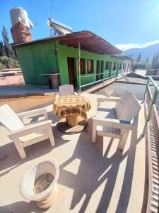 a patio with chairs and a table and a building at El Shaddai in Tilcara +29 photos