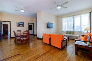 a living room with a couch and a table and chairs at Telamar Resort in Tela