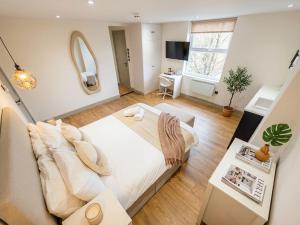 a bedroom with a large bed and a living room at Clapton Station Luxury Studios near Central London in London