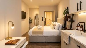 a bedroom with a bed and a sink in a room at Clapton Station Luxury Studios near Central London in London