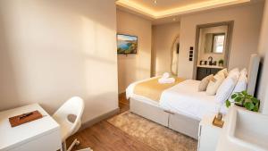 a bedroom with a large bed with a mirror at Clapton Station Luxury Studios near Central London in London +11 photos
