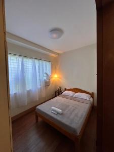 a bedroom with a bed and a window at The RM Homestay in Baclayon +5 photos