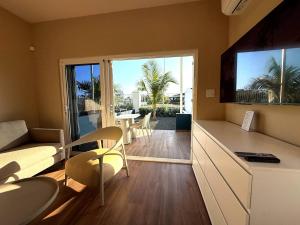 a living room with a couch and a table with chairs at Villa Amalie & Villa Curiel in Willemstad