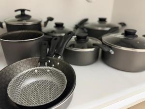 a group of pots and pans on a stove at Prime BNB 1005 Experiência Premium in Petrolina