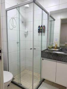 a bathroom with a glass shower with a toilet and a sink at Prime BNB 1005 Experiência Premium in Petrolina
