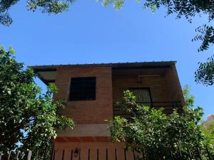 a brick building with a fence in front of it at Departamento en Lambare in Asunción