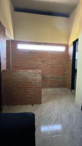 an empty room with a brick wall and a light at Departamento en Lambare in Asunción