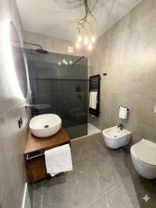 a bathroom with a sink and a toilet and a mirror at GB home in Azzano San Paolo +4 photos
