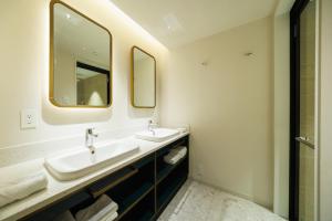 a bathroom with two sinks and a mirror at HOTEL METROPOLITAN OIMACHI TRACKS Tokyo in Tokyo +19 photos