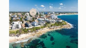 an aerial view of a beach with buildings and the ocean at Beachside Apartment Blackwoods Beach in Cronulla
