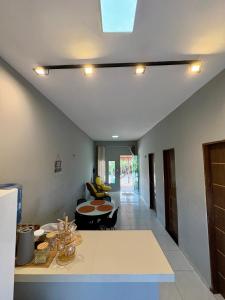 a kitchen and living room with a counter and a table at Varanda das Dunas in Santo Amaro +9 photos