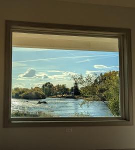 a view of a river from a window at Henrys Fork Suites Suite One in Saint Anthony +2 photos