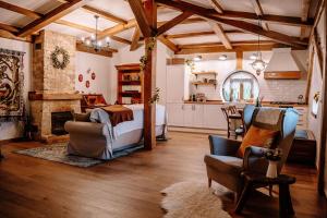 a bedroom with a bed and a kitchen with a fireplace at La Comarca de Vératton in Villanueva de la Vera