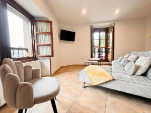 a living room with a couch and a chair at Apartamentos Rurales LLeguera in Llanes