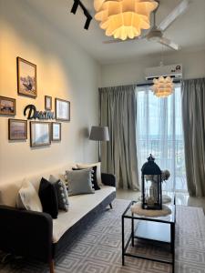 a living room with a couch and a table at daisy apartment taiping in Taiping +1 photo