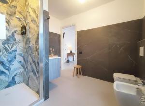 a bathroom with a shower and a toilet and a sink at BB Cadore casa vacanze in Varese