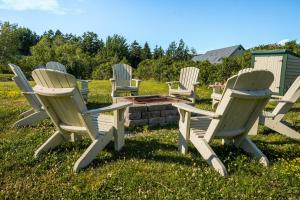 a group of chairs sitting around a fire pit at Harbor Ridge in Southwest Harbor
