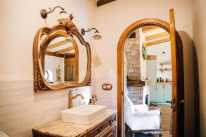 a bathroom with a sink and a mirror at La Comarca de Vératton in Villanueva de la Vera +71 photos