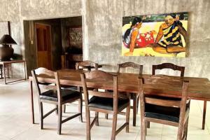 a dining room with a wooden table and chairs at Caba La Union Gulfside Cottage C2 in Caba