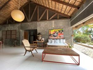a living room with a couch and a table at Caba La Union Gulfside Cottage C2 in Caba