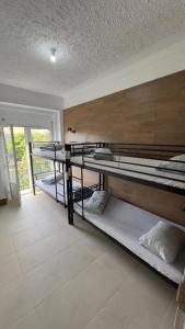 a room with three bunk beds in a house at Samps Hostel in Lisbon