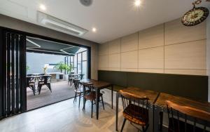 a dining room with wooden tables and chairs at 호텔이데아 울산삼산점 in Ulsan