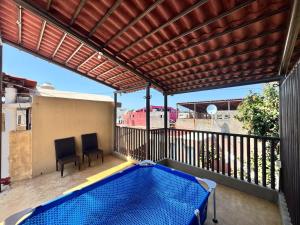 a swimming pool on a balcony with a pergola at Rent Casa La Moraleja in Ixtapa