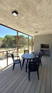 a patio with a table and chairs on a deck at Almarena La Reserva UF 112 in Costa del Este