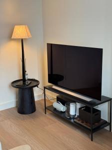 a living room with a large flat screen tv at Boutique Apartment Perenne in Maastricht