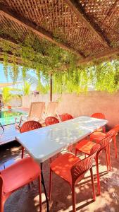 a table and chairs sitting under a pergola at Pacific Blue in Monterrico