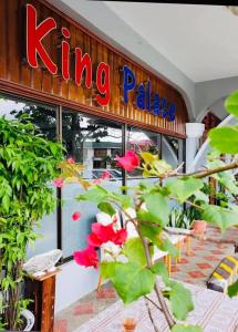 a kinking palace restaurant with red flowers in front of it at Palau Paradise Comfort in Koror
