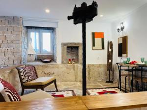 a living room with a fireplace and a table at Largo de Santa Ana in Cadaval