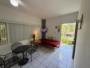 a living room with a red couch and a table at Suites Galván centro Colima, alberca, Wifi, parking in Colima