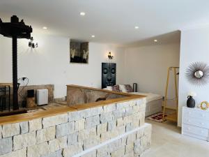 a living room with a brick wall and a table at Largo de Santa Ana in Cadaval