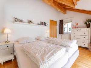 a white bed in a bedroom with a wooden ceiling at Gailblick in Kötschach