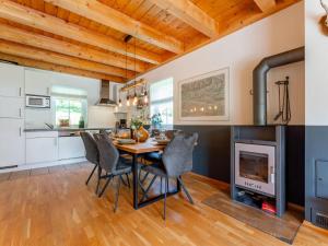 a kitchen and dining room with a table and a fireplace at Gailblick in Kötschach