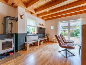 a living room with a chair and a fireplace at Gailblick in Kötschach