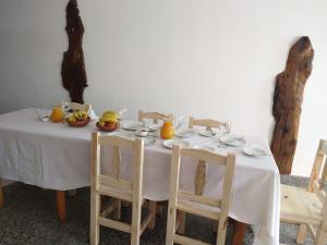a white table with chairs and fruit on it at Camino del Inca in Cachí
