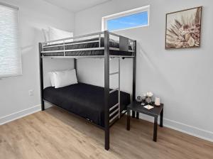 a black bunk bed in a room with a table at Terrace at Two Rivers townhouse in Grand Junction