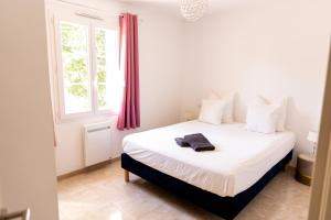 a bedroom with a large white bed with a window at La Villa Sable en Provence in Saint-Saturnin-lès-Apt +56 photos