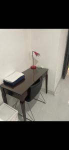 a desk with a laptop and a lamp on it at Bedroom with Bathroom 1 in Boca Raton