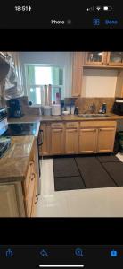 a kitchen with wooden cabinets and a counter top at Bedroom with Bathroom 1 in Boca Raton