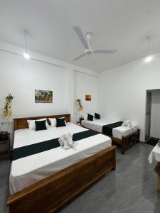 a bedroom with two beds in a room at Tuskers edge Retreat in Udawalawe