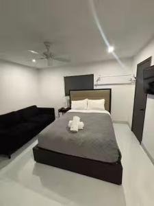 a bedroom with a large bed with a black bed frame at Bedroom with Bathroom 1 in Boca Raton