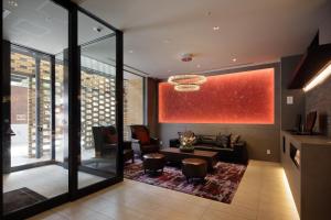 a living room with a couch and a table at Via Inn Umeda in Osaka