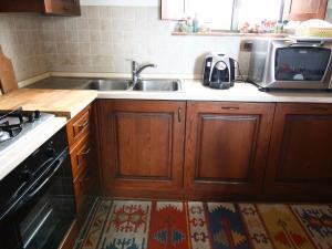 A kitchen or kitchenette at Farmhouse in Asciano with Pool and Countryside