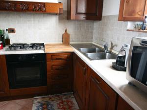 A kitchen or kitchenette at Farmhouse in Asciano with Pool and Countryside