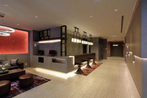 a lobby of a hotel with couches and chairs and a lobby at Via Inn Umeda in Osaka
