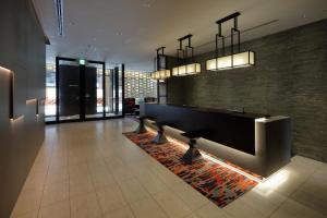 a lobby with a reception desk in a building at Via Inn Umeda in Osaka +50 photos