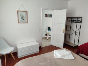a white room with a white chair and a door at Sea Bay House in Lagoa
